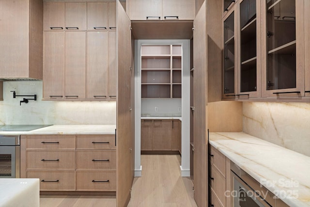 78 Running Creek Trl Unit 93, Arden, NC 28704 - kitchen with oven, light wood-type flooring, black electric stovetop, light brown cabinets, and tasteful backsplash