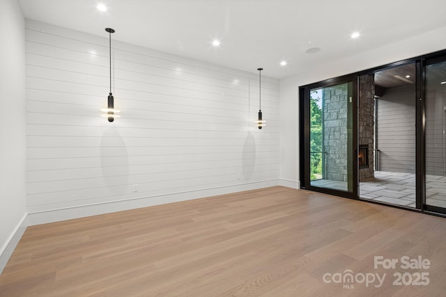 78 Running Creek Trl Unit 93, Arden, NC 28704 - empty room featuring wood finished floors, baseboards, recessed lighting, and a warm lit fireplace