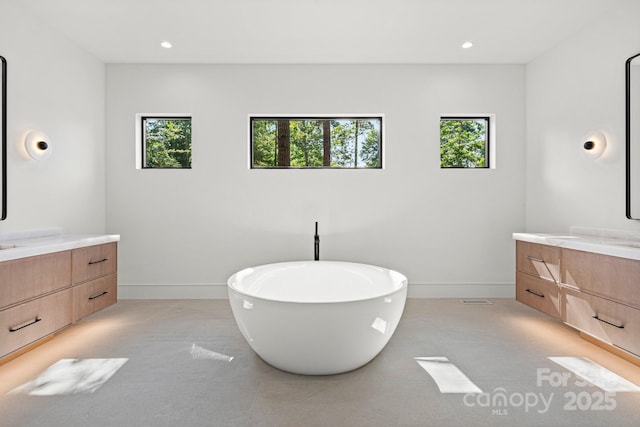 78 Running Creek Trl Unit 93, Arden, NC 28704 - full bathroom with baseboards, two vanities, a soaking tub, and recessed lighting