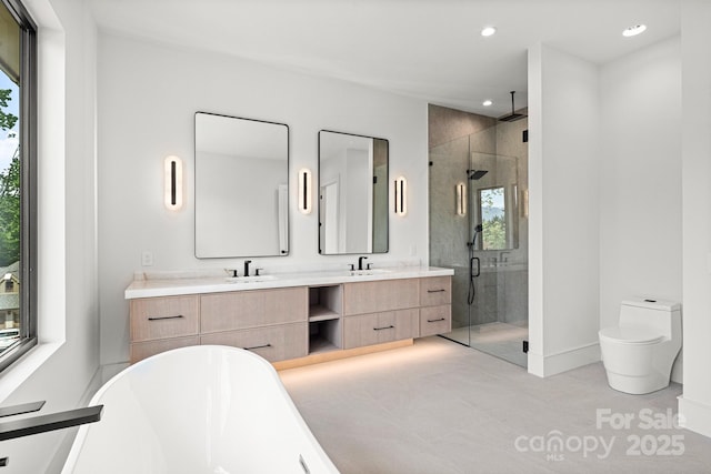 78 Running Creek Trl Unit 93, Arden, NC 28704 - bathroom with healthy amount of natural light, a shower stall, a freestanding bath, double vanity, and recessed lighting