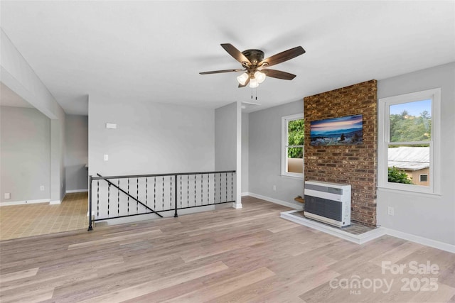 428 Jackson Rd, Fletcher, NC 28732 - unfurnished living room with wood finished floors, heating unit, a ceiling fan, and baseboards