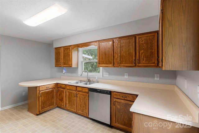 428 Jackson Rd, Fletcher, NC 28732 - kitchen with stainless steel dishwasher, a sink, a peninsula, light countertops, and brown cabinets