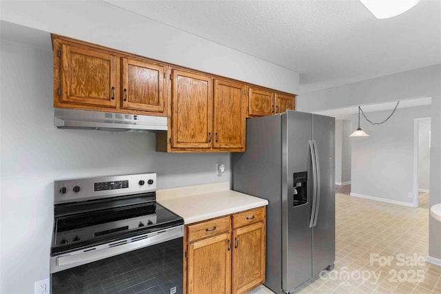 428 Jackson Rd, Fletcher, NC 28732 - kitchen with under cabinet range hood, appliances with stainless steel finishes, light countertops, brown cabinetry, and baseboards