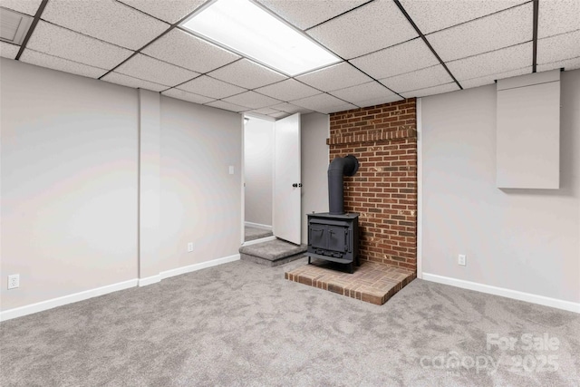 428 Jackson Rd, Fletcher, NC 28732 - finished basement with a wood stove, carpet floors, baseboards, and a paneled ceiling