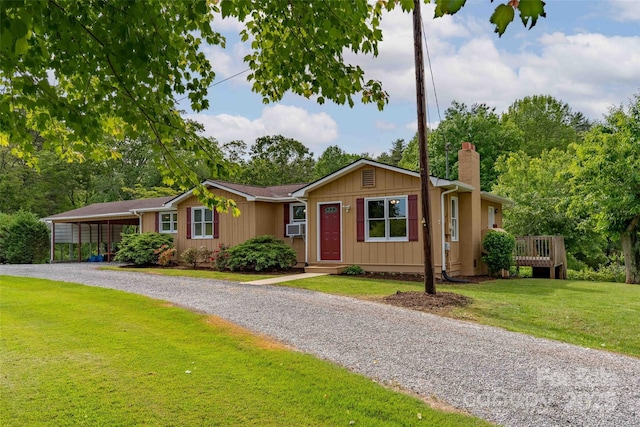 428 Jackson Rd, Fletcher, NC 28732 - ranch-style house with driveway, a chimney, a front lawn, cooling unit, and a carport