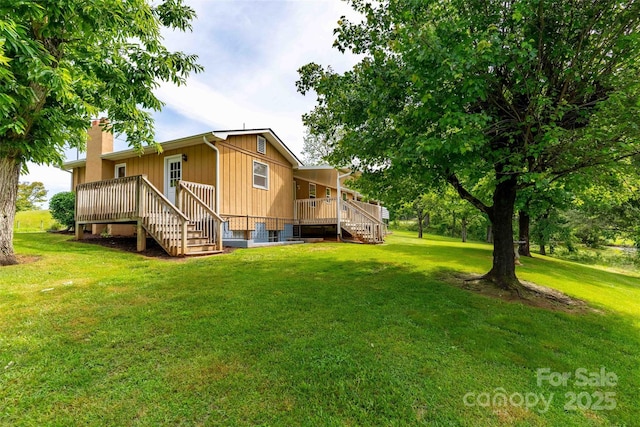 428 Jackson Rd, Fletcher, NC 28732 - back of house featuring stairway, a wooden deck, a lawn, and a chimney