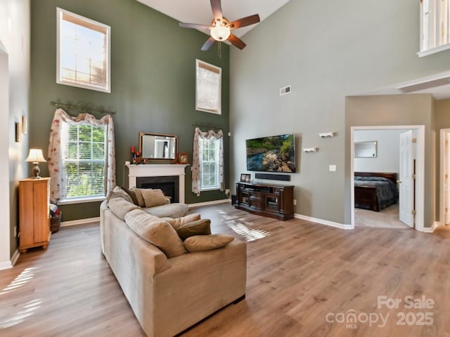 1564 Trippett St NW, Concord, NC 28027 - living area with high vaulted ceiling, ceiling fan, healthy amount of natural light, and baseboards