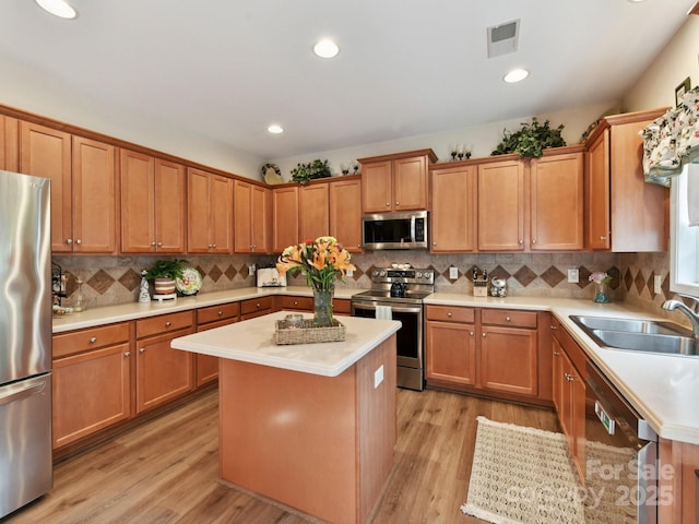 1564 Trippett St NW, Concord, NC 28027 - kitchen with appliances with stainless steel finishes, a sink, light countertops, light wood-style flooring, and recessed lighting