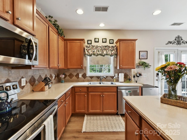 1564 Trippett St NW, Concord, NC 28027 - kitchen featuring stainless steel appliances, a sink, plenty of natural light, light countertops, and recessed lighting