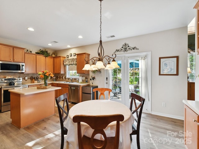 1564 Trippett St NW, Concord, NC 28027 - kitchen with appliances with stainless steel finishes, a sink, light wood-type flooring, healthy amount of natural light, and recessed lighting