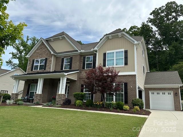 10800 Alabaster Dr, Davidson, NC 28036 - craftsman-style house featuring a garage, concrete driveway, brick siding, and a front yard
