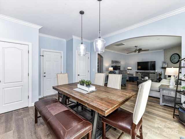 10800 Alabaster Dr, Davidson, NC 28036 - dining space featuring arched walkways, ceiling fan, wood finished floors, ornamental molding, and baseboards