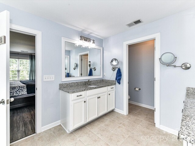 10800 Alabaster Dr, Davidson, NC 28036 - ensuite bathroom featuring vanity, baseboards, toilet, and tile patterned floors