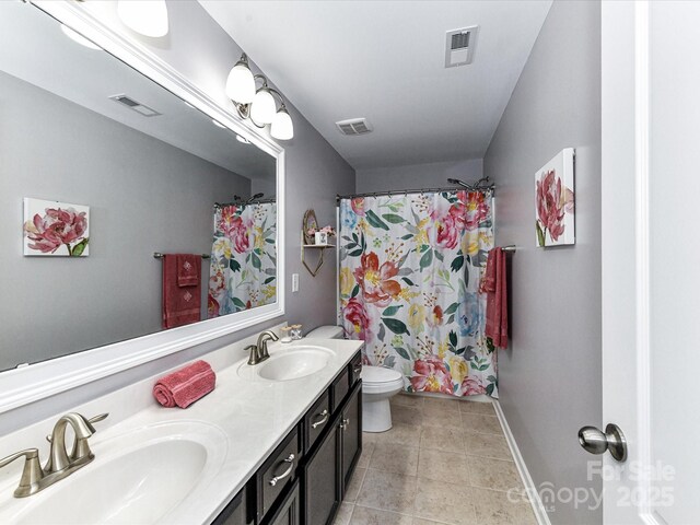 10800 Alabaster Dr, Davidson, NC 28036 - bathroom featuring double vanity, toilet, baseboards, tile patterned floors, and a shower with shower curtain
