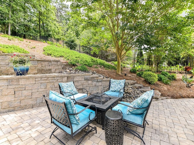 10800 Alabaster Dr, Davidson, NC 28036 - fenced backyard featuring a patio, an outdoor fire pit, and view of wooded area