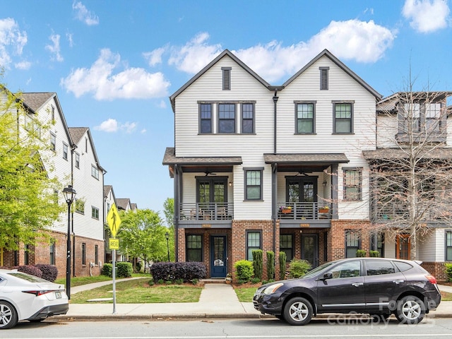 view of property featuring brick siding and a balcony