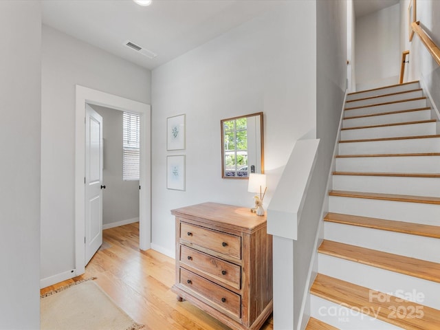 stairs featuring wood finished floors and baseboards