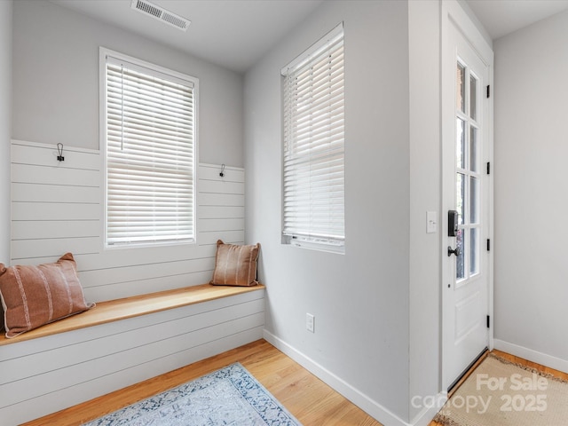 living area with light wood-type flooring and baseboards
