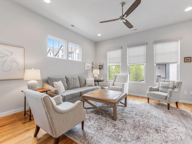 living room with recessed lighting, ceiling fan, baseboards, and light wood-type flooring
