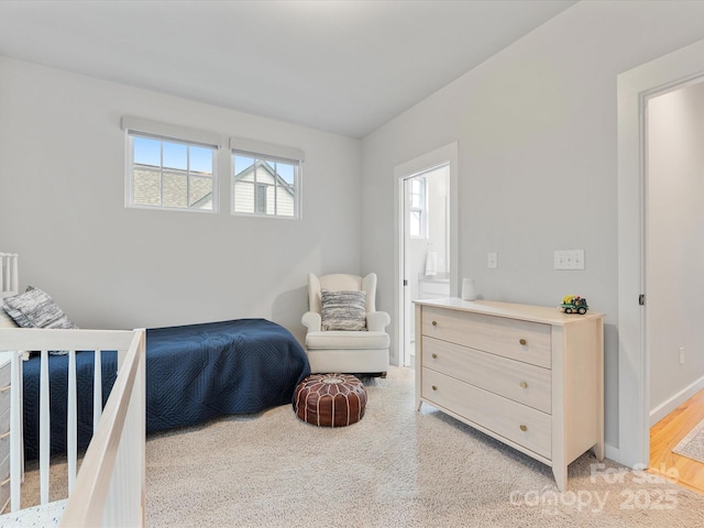 bedroom with light colored carpet and baseboards