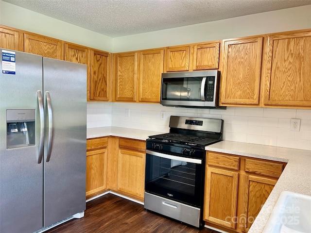 710 Woodington Ln, Charlotte, NC 28214 - kitchen featuring stainless steel appliances, light countertops, backsplash, and a textured ceiling
