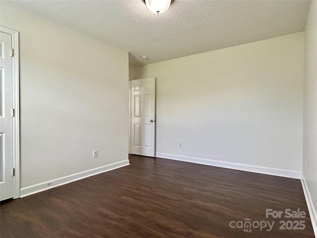 710 Woodington Ln, Charlotte, NC 28214 - empty room with dark wood-style flooring, baseboards, and a textured ceiling