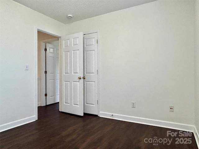 710 Woodington Ln, Charlotte, NC 28214 - unfurnished bedroom with dark wood-style flooring and baseboards