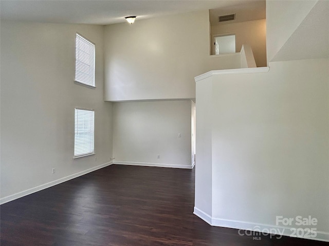 710 Woodington Ln, Charlotte, NC 28214 - empty room featuring dark wood finished floors, plenty of natural light, and baseboards