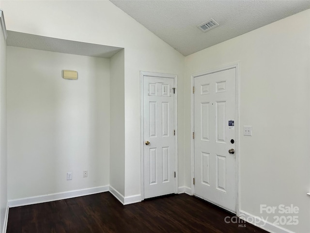 710 Woodington Ln, Charlotte, NC 28214 - foyer with dark wood-style floors, lofted ceiling, and baseboards
