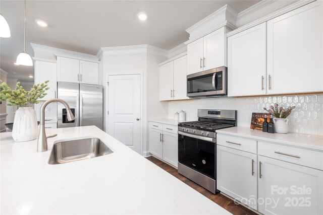 128 S Shayna Rd, Troutman, NC 28166 - kitchen with appliances with stainless steel finishes, a sink, crown molding, tasteful backsplash, and light countertops