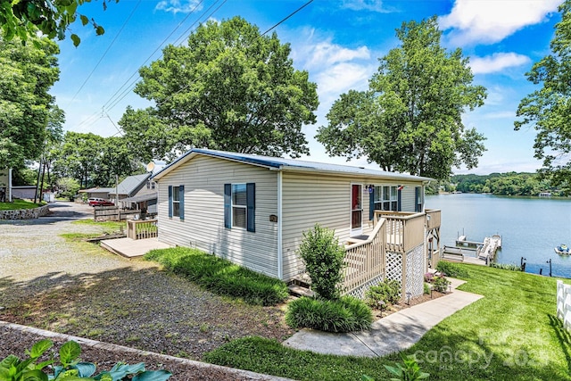 4920 Longfield St, Claremont, NC 28610 - view of property exterior featuring a deck with water view, a yard, and a boat dock