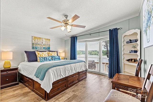 4920 Longfield St, Claremont, NC 28610 - bedroom with vaulted ceiling, a textured ceiling, access to exterior, light wood-type flooring, and ceiling fan
