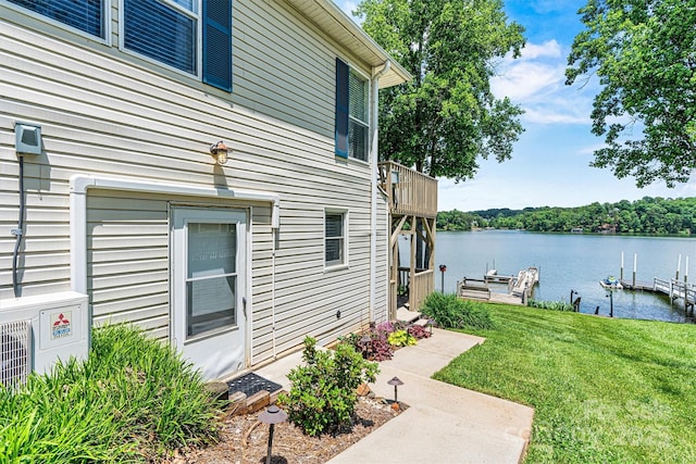 4920 Longfield St, Claremont, NC 28610 - view of home's exterior with a boat dock, a water view, a lawn, and a cooling unit