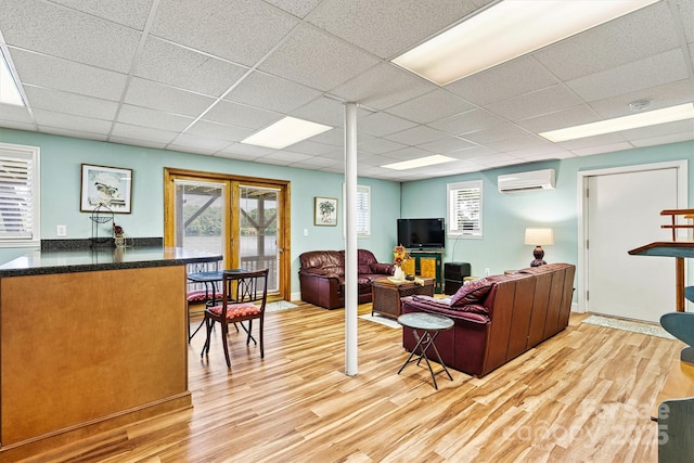 4920 Longfield St, Claremont, NC 28610 - living area with a wall mounted AC, a paneled ceiling, and light wood-style flooring