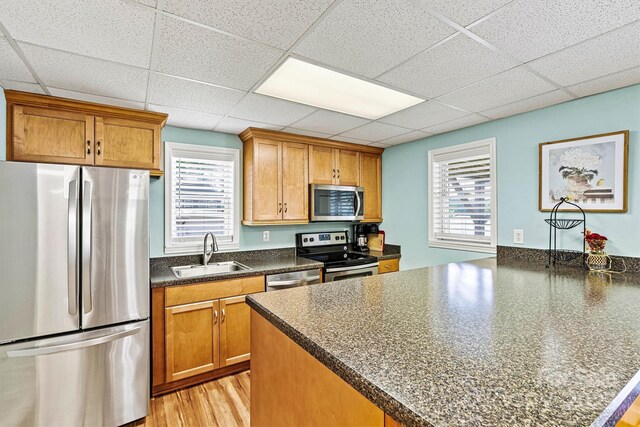 4920 Longfield St, Claremont, NC 28610 - kitchen with stainless steel appliances, a sink, a peninsula, dark countertops, and brown cabinets