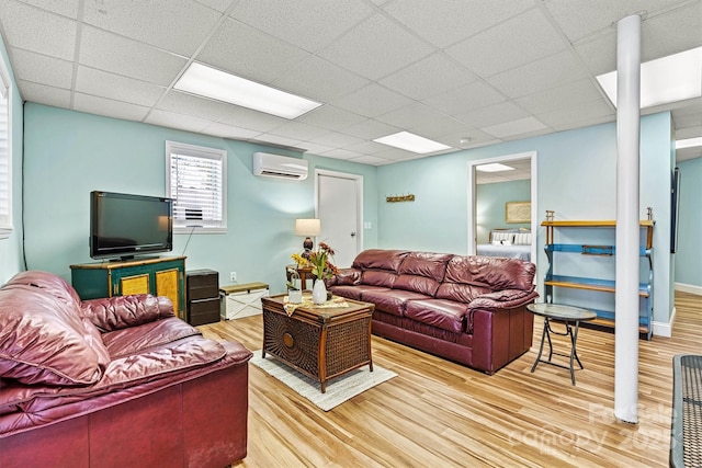 4920 Longfield St, Claremont, NC 28610 - living room featuring a wall unit AC, light wood-type flooring, and a drop ceiling