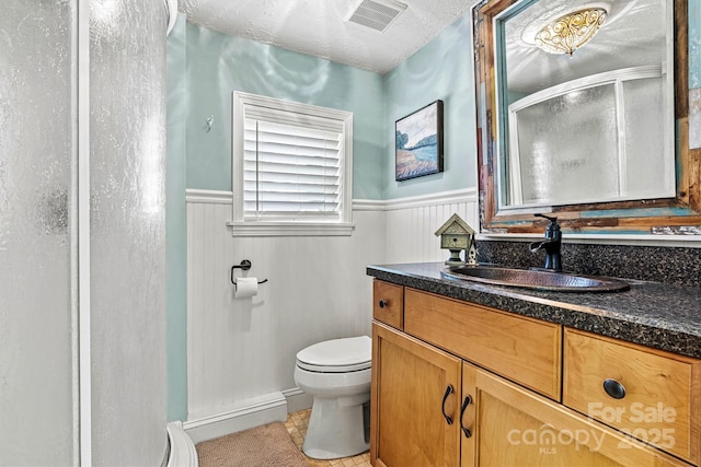 4920 Longfield St, Claremont, NC 28610 - bathroom featuring toilet, a shower stall, wainscoting, vanity, and tile patterned flooring