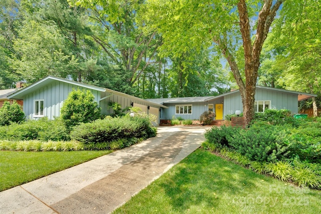 331 Glen Oaks Rd, Charlotte, NC 28270 - view of front of house featuring concrete driveway, board and batten siding, and a front lawn