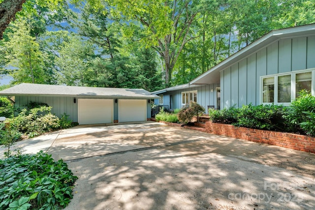 331 Glen Oaks Rd, Charlotte, NC 28270 - ranch-style house featuring an attached garage, board and batten siding, and driveway