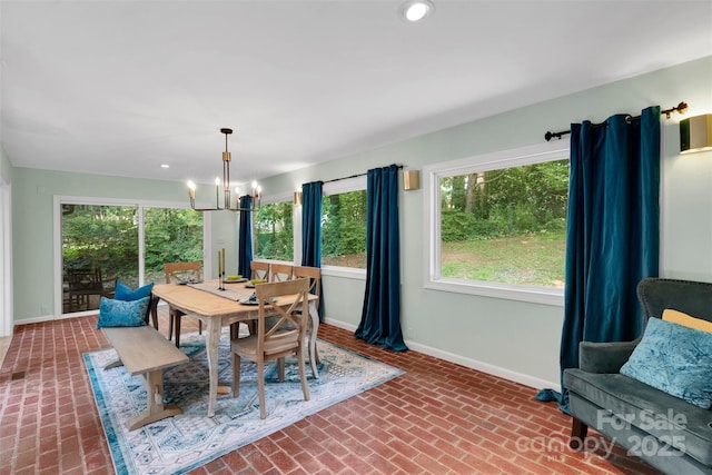 331 Glen Oaks Rd, Charlotte, NC 28270 - dining area featuring brick floors, baseboards, a chandelier, healthy amount of natural light, and recessed lighting