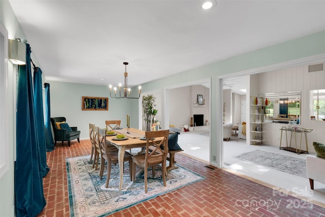 331 Glen Oaks Rd, Charlotte, NC 28270 - dining area with brick flooring, a chandelier, recessed lighting, and baseboards