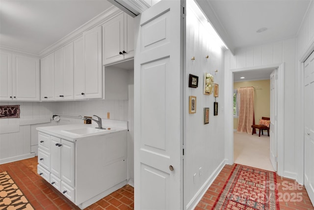331 Glen Oaks Rd, Charlotte, NC 28270 - laundry area featuring a sink, brick floors, and baseboards
