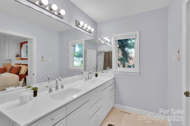 331 Glen Oaks Rd, Charlotte, NC 28270 - ensuite bathroom with tile patterned floors, double vanity, and baseboards