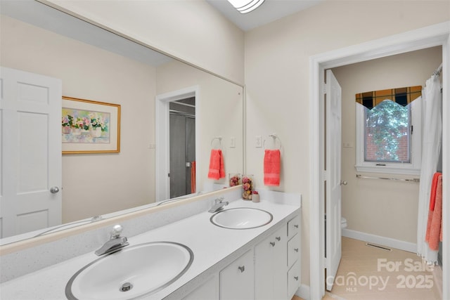 331 Glen Oaks Rd, Charlotte, NC 28270 - full bathroom featuring double vanity, toilet, tile patterned flooring, and a shower
