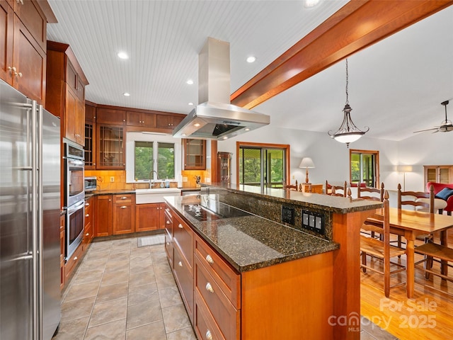 301 Fairway Ln, Spruce Pine, NC 28777 - kitchen with appliances with stainless steel finishes, a sink, island range hood, a center island, and glass insert cabinets