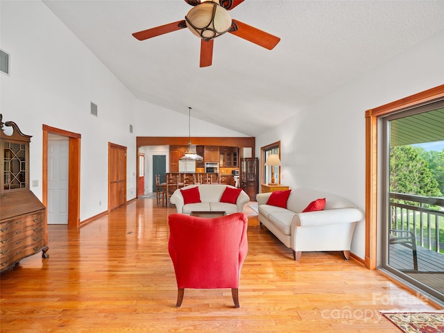 301 Fairway Ln, Spruce Pine, NC 28777 - living room with light wood-style floors, ceiling fan, baseboards, and high vaulted ceiling