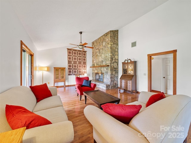 301 Fairway Ln, Spruce Pine, NC 28777 - living area with a ceiling fan, wood finished floors, a fireplace, high vaulted ceiling, and baseboards