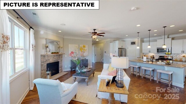 124 S Shayna Rd, Troutman, NC 28166 - living room with a stone fireplace, baseboards, a ceiling fan, ornamental molding, and recessed lighting
