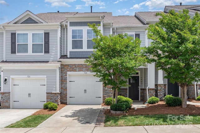 724 Little Bluestem Dr, Lake Wylie, SC 29710 - townhome / multi-family property with stone siding, driveway, an attached garage, and roof with shingles