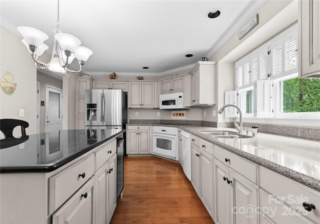 4101 Fairway Downs Ct Unit 9, Charlotte, NC 28277 - kitchen with a sink, white appliances, ornamental molding, a chandelier, and light wood-style floors